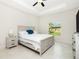 Bright bedroom with tray ceilings features neutral colors, a ceiling fan, and a backyard view at 1384 Alpinia Rd, North Port, FL 34288