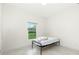 Bright bedroom features neutral colors, a window, and a minimalist style at 1384 Alpinia Rd, North Port, FL 34288