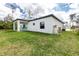Exterior view of the house and well-maintained lawn, showcasing the outdoor water filtration system at 1384 Alpinia Rd, North Port, FL 34288