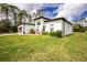 Landscaped front yard showcasing the home's exterior and a separate garage building at 1384 Alpinia Rd, North Port, FL 34288