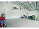 This garage has tall ceilings, epoxy floors, and room for storage at 1384 Alpinia Rd, North Port, FL 34288