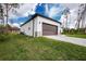 View of the home's garage with a large, paneled door and paver driveway at 1384 Alpinia Rd, North Port, FL 34288