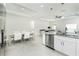 Open floor plan features a bright kitchen, dining area, and living room with neutral tones at 1384 Alpinia Rd, North Port, FL 34288