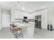 Modern kitchen featuring granite countertops, stainless steel appliances, and seating at the island at 1384 Alpinia Rd, North Port, FL 34288