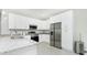 Modern kitchen with stainless steel appliances, granite countertops, and ample storage space at 1384 Alpinia Rd, North Port, FL 34288