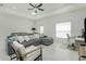 Comfortable living room featuring a gray sectional sofa with decorative pillows and a ceiling fan at 1384 Alpinia Rd, North Port, FL 34288