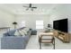 Bright living room features a modern workspace, comfortable seating, and an open layout at 1384 Alpinia Rd, North Port, FL 34288