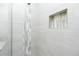 Modern shower design with sleek tile, built-in niche, and rainfall showerhead at 1384 Alpinia Rd, North Port, FL 34288
