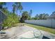 Spacious backyard with a patio, green lawn, and white fence, perfect for outdoor activities at 1406 Woodcrest, North Port, FL 34286