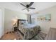 Comfortable bedroom with ceiling fan, queen bed with decorative pillows, and natural light from the window at 1406 Woodcrest, North Port, FL 34286