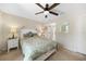 Bright bedroom with a bed, side tables, lamps, and a ceiling fan creates a relaxing atmosphere at 1406 Woodcrest, North Port, FL 34286