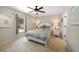Cozy bedroom featuring a comfortable bed, bedside tables with lamps, and a ceiling fan at 1406 Woodcrest, North Port, FL 34286