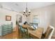 Dining room with seating for six, enhanced by tile flooring, a chandelier and bright natural light at 1406 Woodcrest, North Port, FL 34286