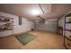 Spacious garage with ample storage shelving, providing room for vehicles and tools at 1406 Woodcrest, North Port, FL 34286