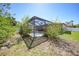 Enclosed screened pool area with a flamingo statue and mature landscaping offering a private outdoor space at 1406 Woodcrest, North Port, FL 34286