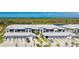 An aerial view of condo buildings showing a tranquil water view and attached garages with a paver driveway at 14281 Heritage Landing Blvd # 1411, Punta Gorda, FL 33955