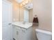 Bathroom featuring a vanity sink and toilet with a large mirror and decorative lighting at 14281 Heritage Landing Blvd # 1411, Punta Gorda, FL 33955