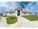 Exterior of the white clubhouse showing the entrance and surrounding landscaping on a sunny day at 14281 Heritage Landing Blvd # 1411, Punta Gorda, FL 33955