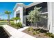 A condo building with a screened in porch, and nicely landscaped at 14281 Heritage Landing Blvd # 1411, Punta Gorda, FL 33955