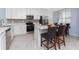 Kitchen with white cabinets, quartz countertops, stainless steel appliances, and tiled floors at 14281 Heritage Landing Blvd # 1411, Punta Gorda, FL 33955