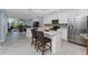 Kitchen with stainless steel appliances, white cabinets and a center island overlooking the living room at 14281 Heritage Landing Blvd # 1411, Punta Gorda, FL 33955