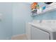 Laundry room with side-by-side washer and dryer and shelving unit at 14281 Heritage Landing Blvd # 1411, Punta Gorda, FL 33955