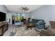 Living room with tile floors, stylish furniture, a ceiling fan, and sliding glass doors at 14281 Heritage Landing Blvd # 1411, Punta Gorda, FL 33955