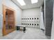 Indoor view of a locker room with tile flooring, lockers, a bench, and a sauna at 14281 Heritage Landing Blvd # 1411, Punta Gorda, FL 33955