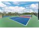 An outdoor pickleball court showing a green surface and blue and red play area, with sunny blue skies above at 14281 Heritage Landing Blvd # 1411, Punta Gorda, FL 33955