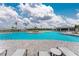 Community pool with lounge chairs and a covered eating area at 14281 Heritage Landing Blvd # 1411, Punta Gorda, FL 33955