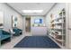 Indoor view of reception area with blue chairs, geometric rug, and shelving with displayed items at 14281 Heritage Landing Blvd # 1411, Punta Gorda, FL 33955