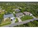An aerial view shows the property, its manicured lawn, and its location in a verdant community at 1508 Westover St, Port Charlotte, FL 33953