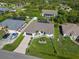 Aerial view shows the property with a manicured lawn, long driveway, and charming landscaping at 1508 Westover St, Port Charlotte, FL 33953