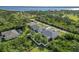 High angle view highlighting a screen enclosed pool and fenced in backyard nestled within a lush neighborhood near the waterfront at 1508 Westover St, Port Charlotte, FL 33953