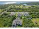 Expansive aerial view showcasing the neighborhood, surrounding green space, and waterfront views of this beautiful property at 1508 Westover St, Port Charlotte, FL 33953