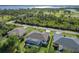 Aerial view shows the backyard pool, manicured lawn, and partial view of a waterway nearby at 1508 Westover St, Port Charlotte, FL 33953