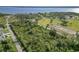 Aerial view of the lot with surrounding wooded lands and overlooking the waterfront at 1508 Westover St, Port Charlotte, FL 33953