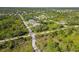 Expansive aerial view of a residential area with lush green trees surrounding single-Gathering homes at 1508 Westover St, Port Charlotte, FL 33953