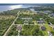 Stunning aerial view showcasing the neighborhood, surrounding green space, and waterfront views of this beautiful property at 1508 Westover St, Port Charlotte, FL 33953