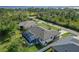 Aerial view of the residence featuring a screen enclosed pool and lush backyard, with waterfront views in the distance at 1508 Westover St, Port Charlotte, FL 33953