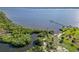 An aerial view features coastal wetlands along a bay with a small dock at 1508 Westover St, Port Charlotte, FL 33953