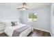 Cozy bedroom with a ceiling fan, natural light, and a comfortable bed with stylish linens at 1508 Westover St, Port Charlotte, FL 33953