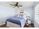Cozy bedroom features a ceiling fan and a comfortable bed with stylish blue quilt at 1508 Westover St, Port Charlotte, FL 33953