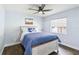 Bedroom featuring a ceiling fan, natural light, and a comfortable bed with stylish linens at 1508 Westover St, Port Charlotte, FL 33953