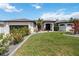 Stunning front exterior of the house with lush landscaping, well-manicured lawn, and a welcoming entrance at 1508 Westover St, Port Charlotte, FL 33953