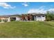 Landscaped front yard with vibrant flowers and a well-maintained lawn, creating a welcoming entrance at 1508 Westover St, Port Charlotte, FL 33953