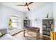 Bright game room featuring a foosball table, ceiling fan, and a large window at 1508 Westover St, Port Charlotte, FL 33953