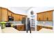 Well-lit kitchen with stainless steel appliances, ample counter space, and a walk-in pantry at 1508 Westover St, Port Charlotte, FL 33953