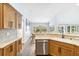 Spacious kitchen with stainless steel dishwasher, countertops, and wood cabinetry at 1508 Westover St, Port Charlotte, FL 33953