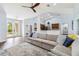 Comfortable living room featuring a large sectional sofa, modern decor, and an open flow to the kitchen at 1508 Westover St, Port Charlotte, FL 33953